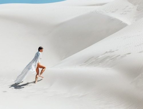 person walking in the sand