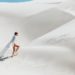 person walking in the sand